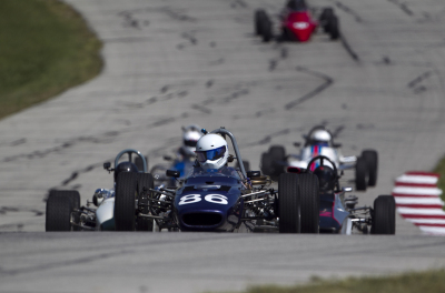 Angus Lemmon leads an angry pack of Group 6 cars up the hill at Hallett